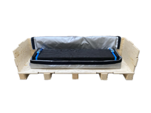 A black rectangular object on a wooden pallet</p>
<p>Description automatically generated