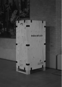 A wooden box with black tape</p>
<p>Description automatically generated