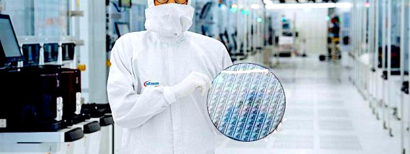 En tekniker i renrummet på Infineon Technologies i Villach, Österrike, håller i ett 300 mm stort galliumnitrid-wafer. Källa: Infineon